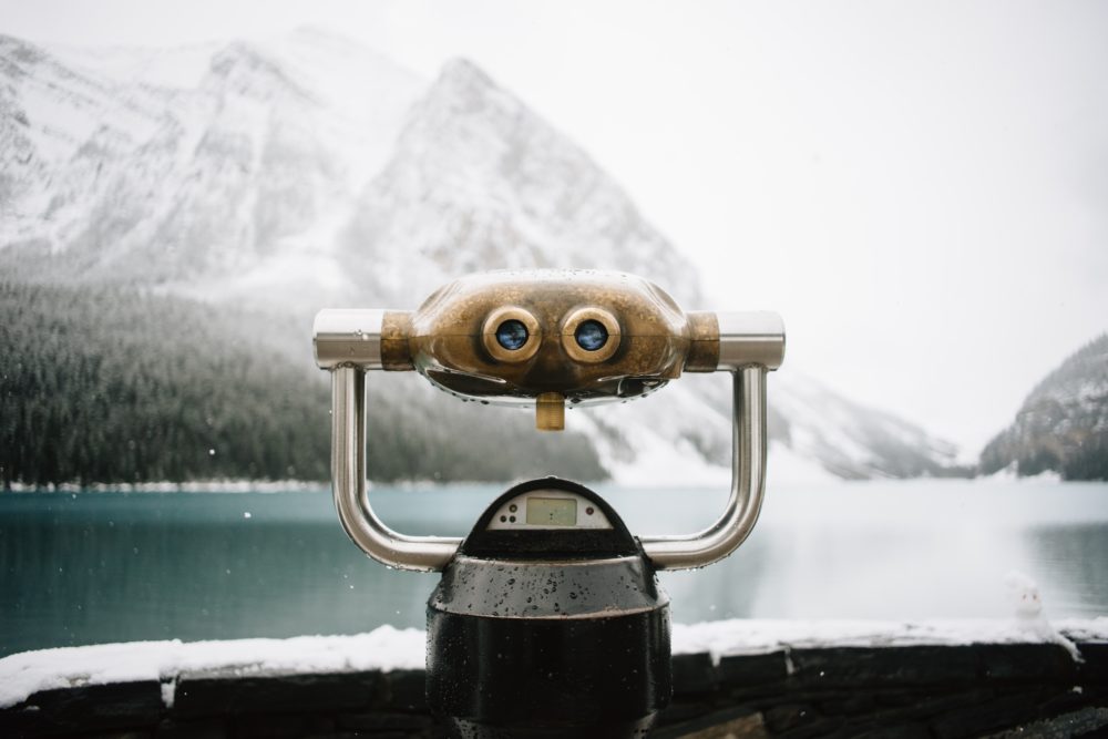 This is an image of Lake Louise in the winter. In the foreground is a view-finder, looking across the lake towards the mountains.